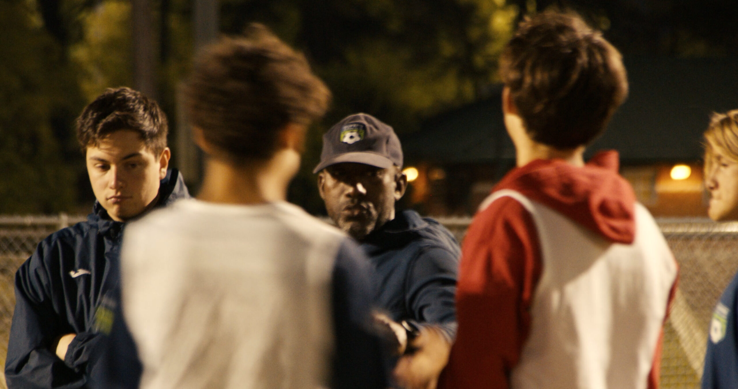 Soccer coaches talking with their team